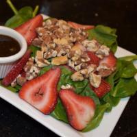Spinach · Strawberries, Walnut, and red onion in sweet red wine vinaigrette.