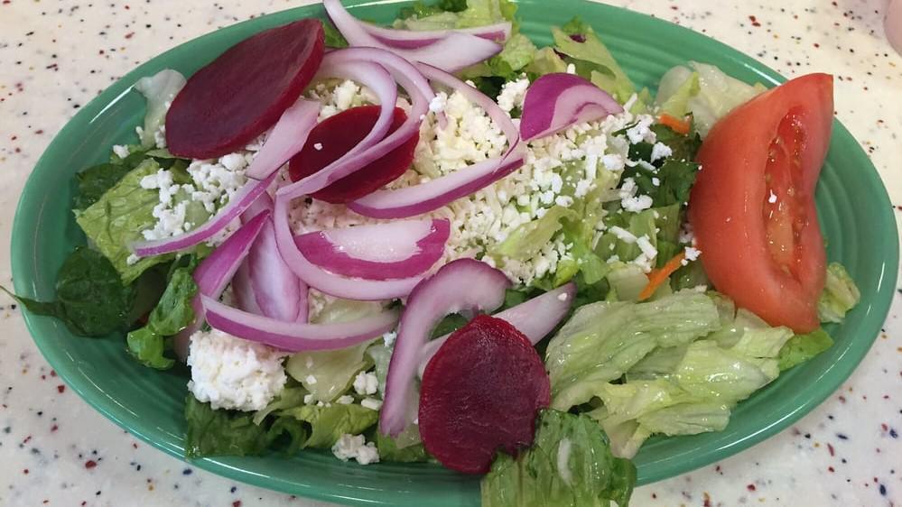Greek Salad · Lettuce, tomatoes, cucumbers, beets, pepperoncini, Greek olives, onions, feta cheese & house-made Greek dressing.