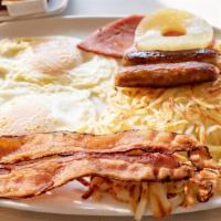 Greek Islands Breakfast · Two eggs, two pork sausage, two bacon strips & one slice of ham with pineapple, served with ...