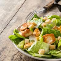 Grilled Chicken Caesar Salad · Classic salad of Romaine lettuce, cucumber, croutons, and Parmesan cheese. Topped with a hea...