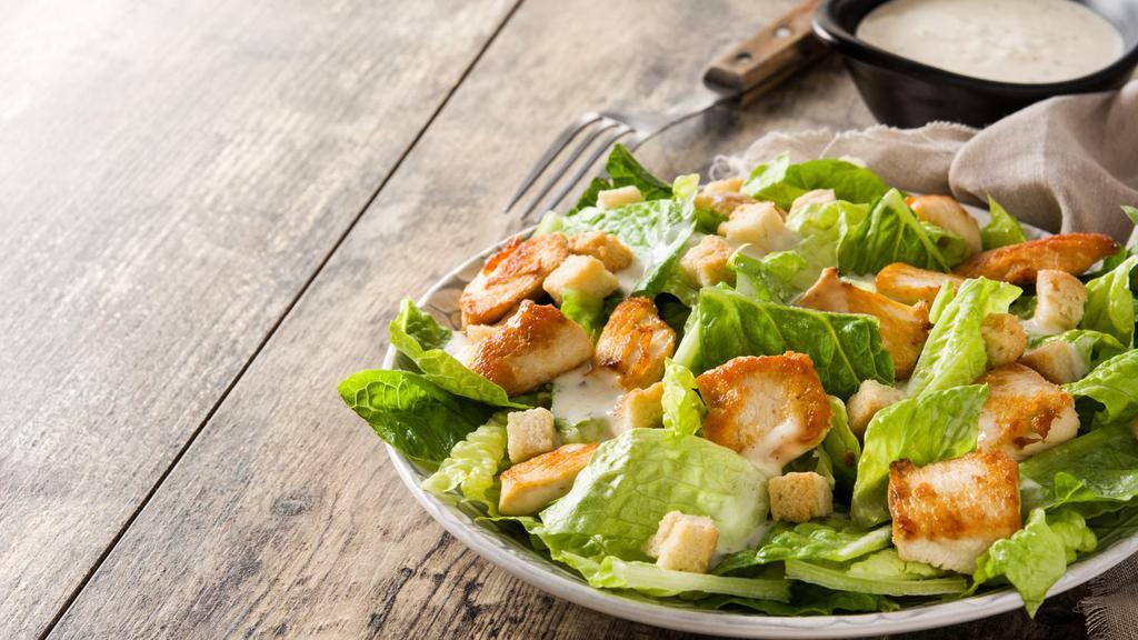 Grilled Chicken Caesar Salad · Classic salad of Romaine lettuce, cucumber, croutons, and Parmesan cheese. Topped with a hearty helping of grilled chicken.