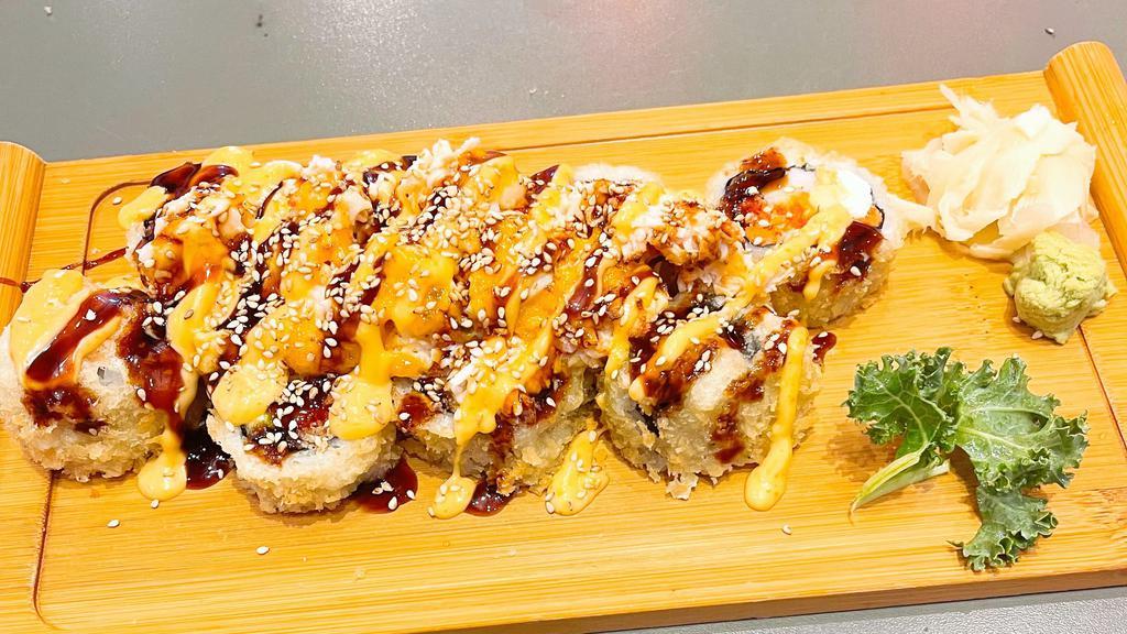Volcano Roll · Tempura with spicy tuna, white fish, avocado and cream cheese topped with grilled scallops crabmeat