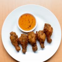 Fried Chicken Wings · Fried Thai Esarn style marinated wings. Served with sweet chili sauce. Five pcs.