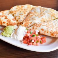 Spicy Chicken Quesadilla · spicy grilled chicken/ co jack cheese/ sauteed onions/poblano peppers/ fresh guacamole/pico ...