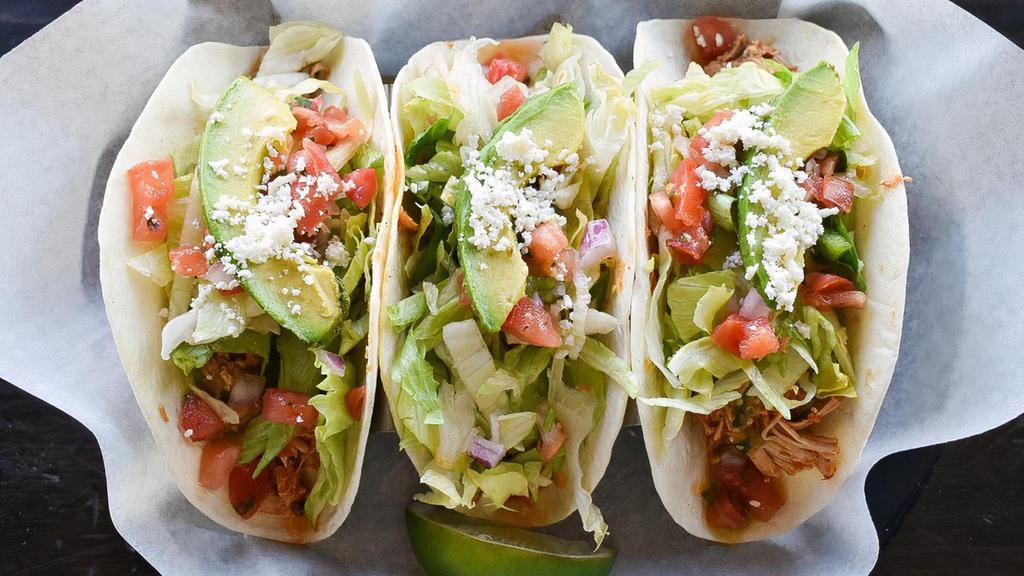 Chicken Tinga Taco · Slow cooked shredded chicken/salsa verde/lettuce/pico de gallo/queso fresco/rice/sour cream/ colby jack cheese