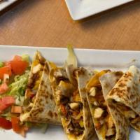 Chicken Quesadilla  · Flour tortilla stuffed with chicken, cheese, grilled onions and grilled peppers. Served with...