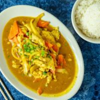 Chicken · Spicy. Yellow curry with chicken, onions, coconut milk, peanut sauce, carrots, and garlic.