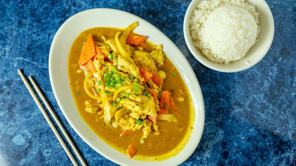 Chicken · Yellow curry with chicken, onions, coconut milk, peanut sauce, carrots, and garlic.