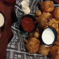 Mozzarella Curds · Beer-battered giant mozzarella curds - we recommend pairing with marinara.