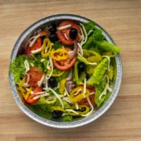 House Salad · Crisp romaine & iceberg lettuce with a mix of red onions & tomatoes, with black olives, bana...