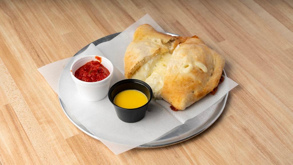 Cheese Calzones · Our made from scratch dough baked with ricotta, mozzarella cheese, and marinara on the side. Create your own with additional toppings!