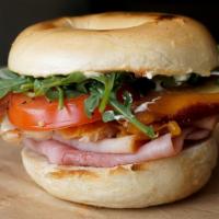 Bakehouse Club  · Ham, Turkey and Bacon stacked high with Arugula, Tomato and scallion cream cheese on a Every...