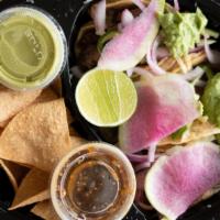 Carne Asada Tacos · Prime flat iron,  marinated cucumber and onion, guacamole, cilantro. radish, guacachile.