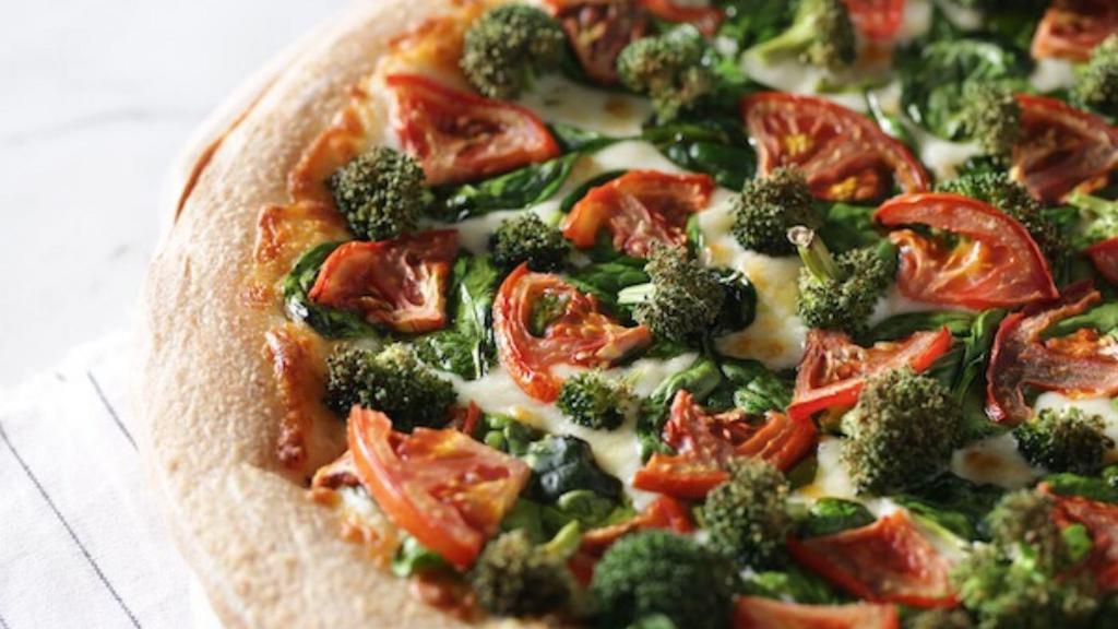 New York White Specialty Pizza · Broccoli, spinach, tomatoes and Wisconsin cheese blend on our buttery garlic sauce.