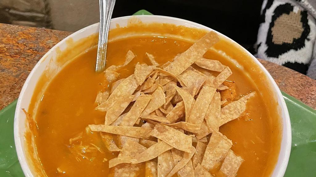 Chicken Tortilla Soup · A flavorful and spicy soup of seasoned chicken with fresh avocado, cilantro and crispy corn tortilla strips.