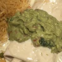 Burrito Don Julio · Seasoned shredded chicken or beef in a grilled flour tortilla topped with white queso sauce ...