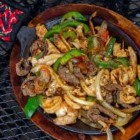 Fajitas Tres Amigos · House favorites. Grilled beef skirt steak, chicken and shrimp with grilled onions and bell p...