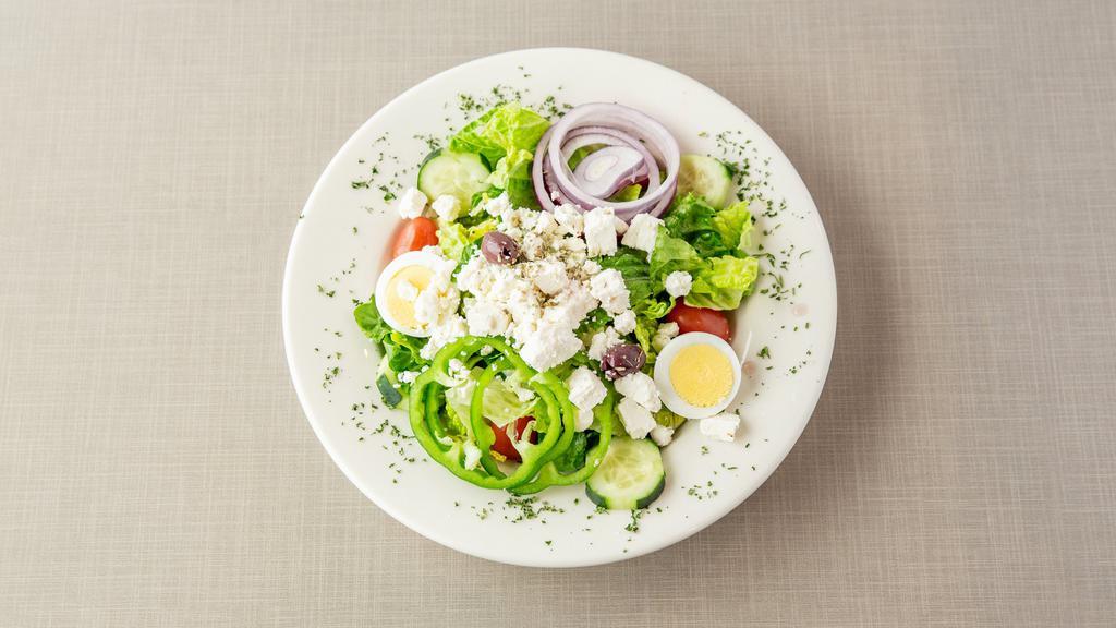 Greek Salad · Mixed greens with tomato wedges, feta cheese, olives, stuffed grape leaves,cucumbers and hard boiled​ egg with Greek dressing.
