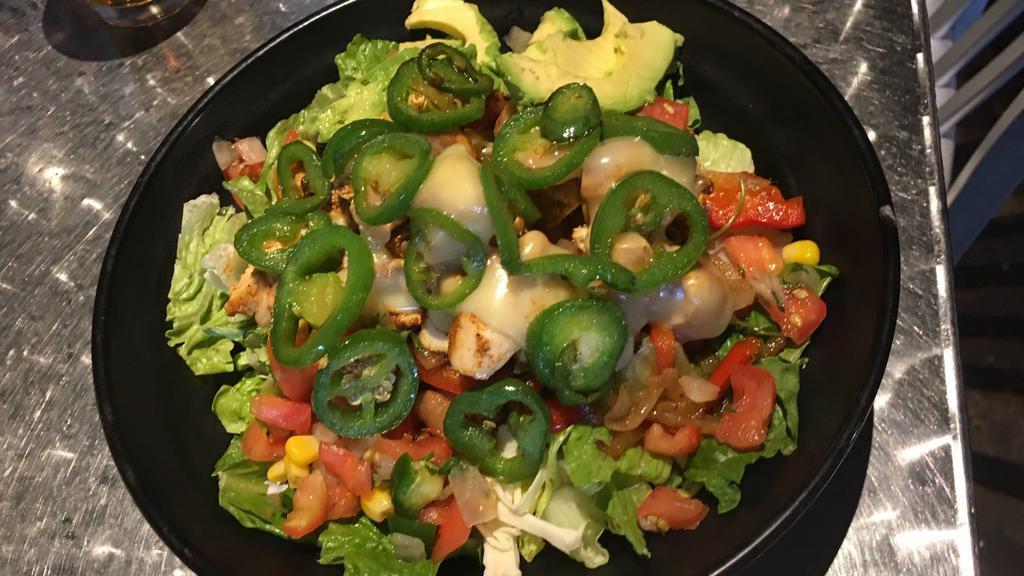 Baja Fajita Salad · Fresh mixed greens, grilled chicken, borracho beans, caramelized onions, bell peppers, melted pepper jack, fried jalapeños, corn pico, avocado, ranch, ranchero salsa.
