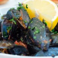 Mussels With Garlic · Delicious fresh mussels cooked in a buttery white wine and garlic sauce.