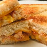 Lobsta Grilled Cheese · butter poached lobster, lemon aioli, american cheese, cheddar cheese, swiss cheese.