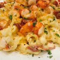 Lobsta Mac · butter poached lobster, campanelle pasta, three cheese blend, 
sun dried tomato, bread crumb