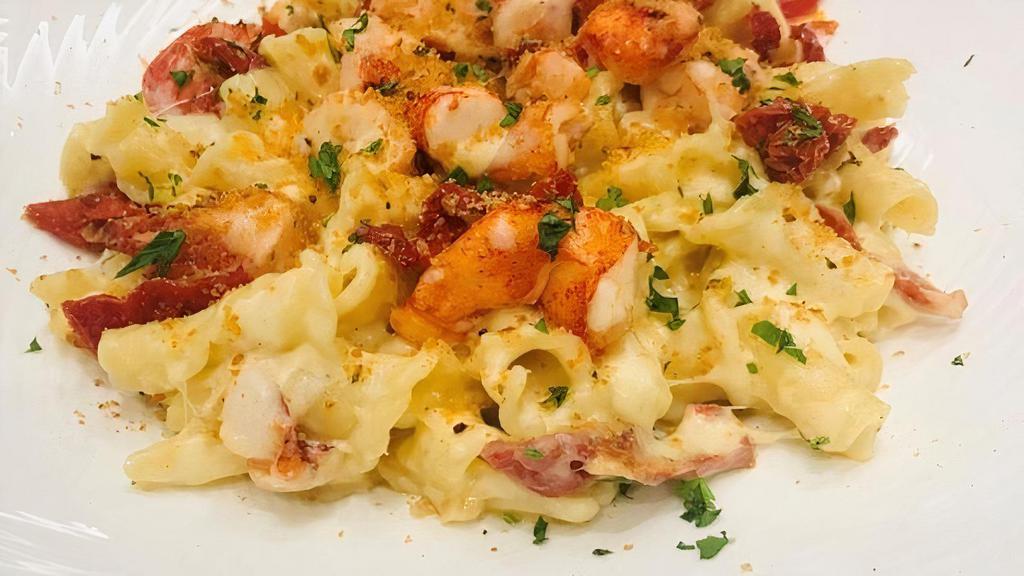 Lobsta Mac · butter poached lobster, campanelle pasta, three cheese blend, 
sun dried tomato, bread crumb