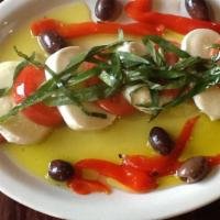 Caprese · Freshly sliced tomato and mozzarella medallions with Kalamata olives, ​roasted red peppers, ...