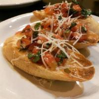 Bruschetta Di Pomodori · Tuscan garlic bread with fresh chopped tomatoes, basil and extra virgin olive oil.