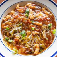 Creamy Cajun Shrimp & Grits · includes smoked sausage, cajun cream sauce, peppers, tomatoes, cheddar, & green onions