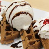 Fudge Brownie Waffle · Topped with vanilla ice cream, whipped cream, cherries, and chocolate drizzle.