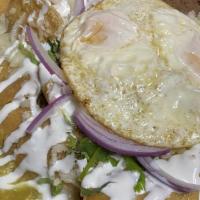 Homemade Chilaquiles · Lightly fried corn tortillas smothered and cooked in fresh red or green homemade sauce toppe...