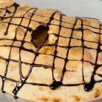 Buckeye Calzone · Homemade peanut butter with Ghirardelli chocolate inside, and chocolate drizzle on top.