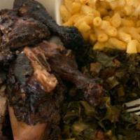 Jerk Dark Lunch · leg and thigh served with two sides and a cup of jerk sauce on the side