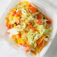 Nachos Supreme · Includes lettuce, tomatoes, onion, salsa, and sour cream.