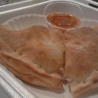 Calzone · Ham, mozzarella and ricotta, with sauce on the side.