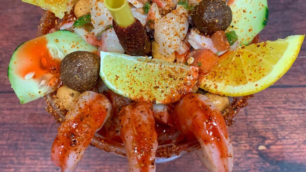 Michelada Especial · 32 oz cup with michelada mix and beer of choice. Additionally it comes with an extra cup filled with mixed ceviche (shrimp, fish & octopus)