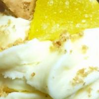 Lemon Crumble · Sweet lemon cake filled with tangy whipped cream, topped in smooth cream cheese rimmed in cr...