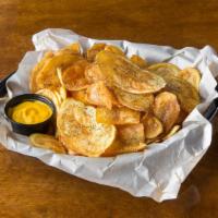 House Chips Basket · Homemade chips with our House Seasoning. Choice of two sauces: cheese, pepper relish, BBQ, c...