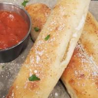 Stuffed Breadsticks · 3 mozzarella cheese filled breadsticks topped with garlic butter, parmesan and served with m...