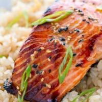 Salmon Over Rice · Diced atlantic salmon grilled onions bell peppers over yellow rice lettuce topped with new y...