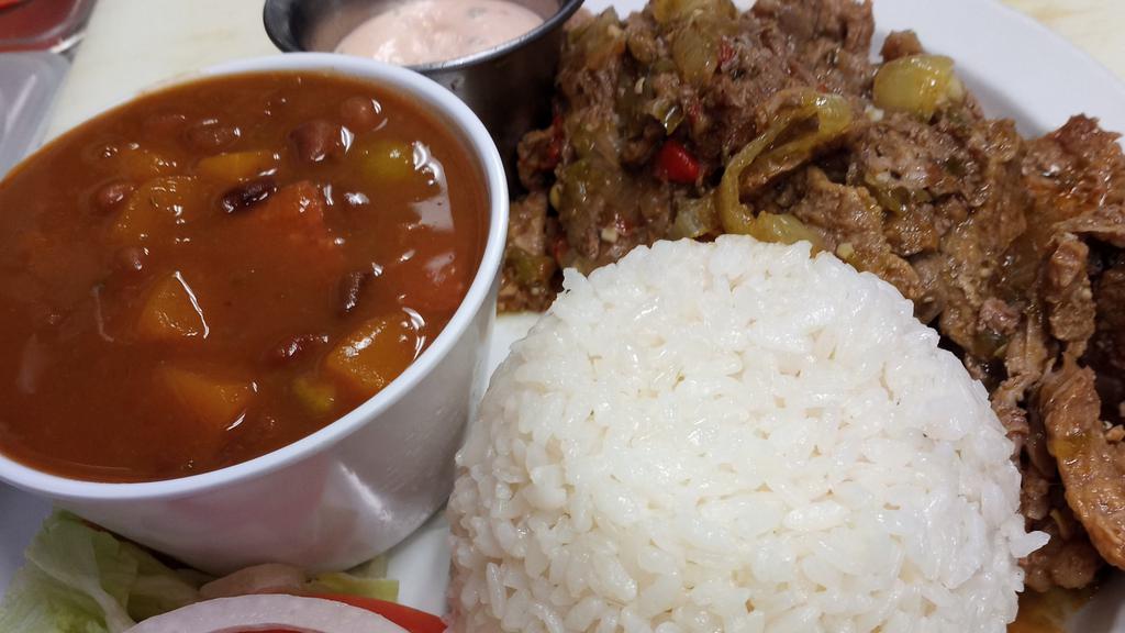 Bistec · Marinated steak and our special sauce. Served with white rice, beans, and salad.