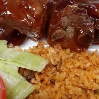 Bbq Ribs · Ribs cooked in our delicious bbq sauce and served with your choice of rice & side.