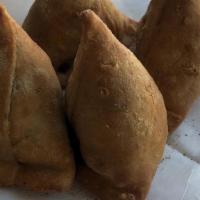 Vegetable Samosas (2) · Home-made pastries stuffed with seasoned potatoes and cooked with peas.