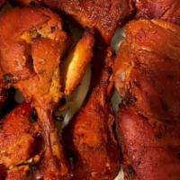 Tandoori Chicken · Whole chicken marinated in exotically spiced yogurt, cooked in clay oven.