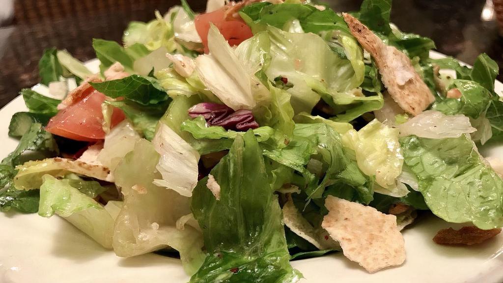 Fattoush Salad · Traditional salad mixed with toasted pita bread.