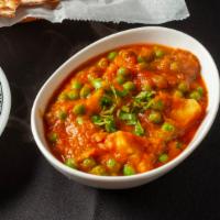 Aloo Mutter · Potatoes and peas cooked in curry sauce.