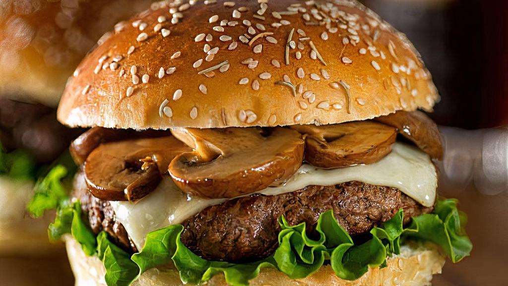 Mushroom Swiss · Single burger with sautéed onions and garlic, portobello mushrooms, lettuce, tomato, Swiss cheese, and a small fry.