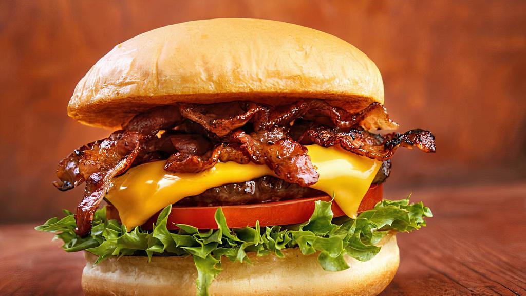 Bacon Cheddar · Single burger with sautéed onions and garlic, lettuce, tomato, Cheddar cheese bacon, and a small fry.