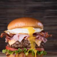 Jerry'S Royale · Single burger with sautéed onions and garlic, over easy egg, lettuce, tomato, American chees...